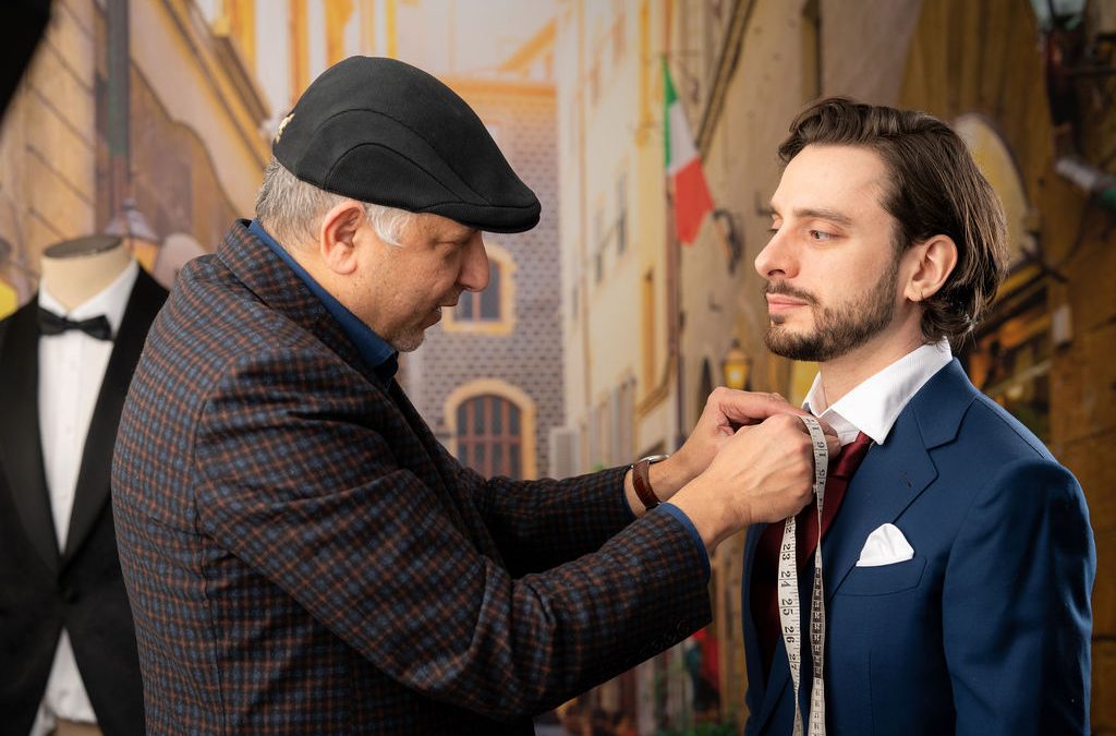 Image: A skilled tailor is shown carefully measuring a real estate agent for a perfectly tailored suit. The tailor's precision and attention to detail highlight the importance of personalized fit and professionalism in the real estate industry. The image captures the collaborative process between the tailor and the agent, symbolizing the significance of tailored attire in making a lasting impression.